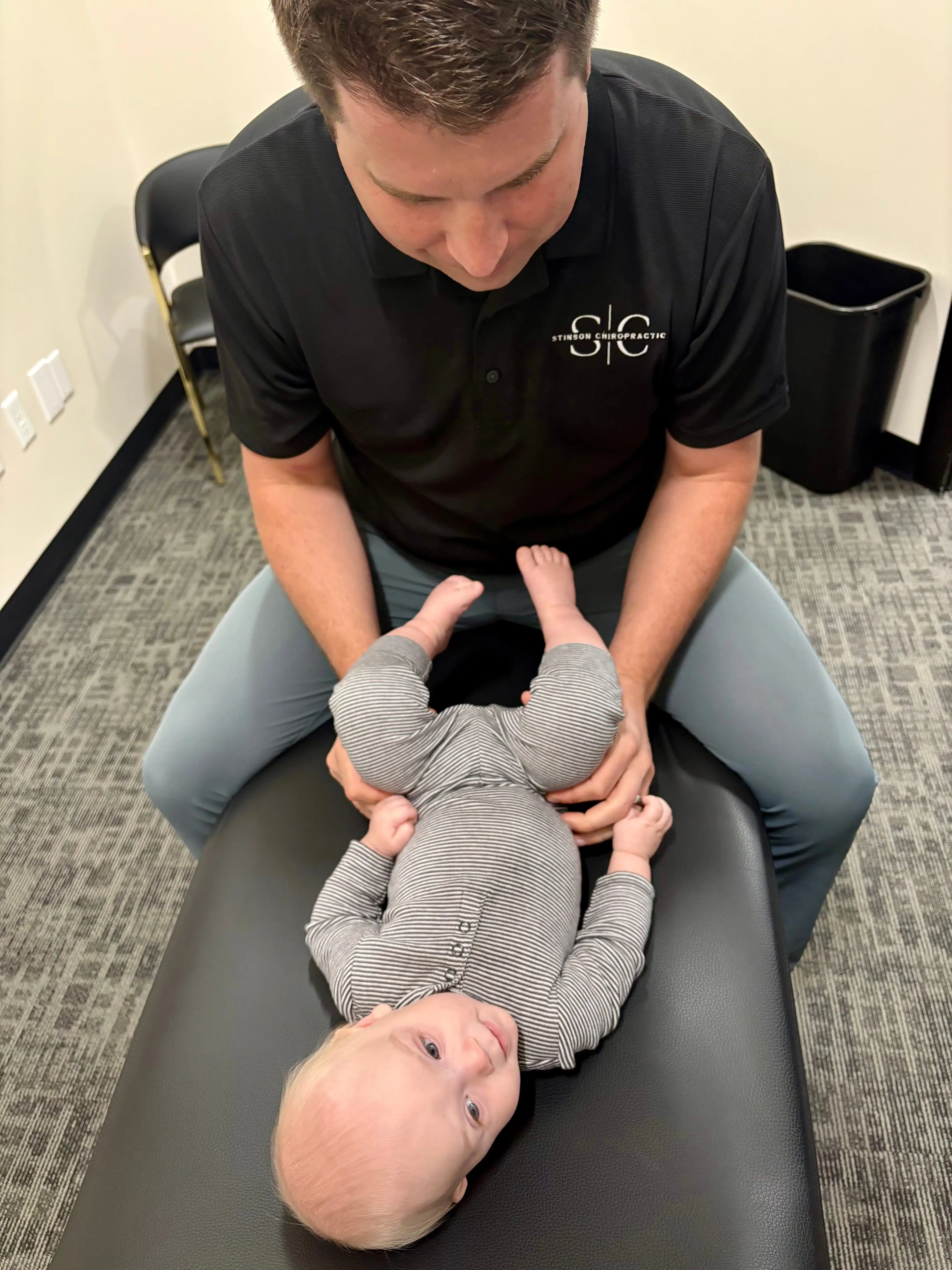 Chiropractor performing spinal adjustment to treat back pain neck pain headaches and various health conditions at Stinson Chiropractic